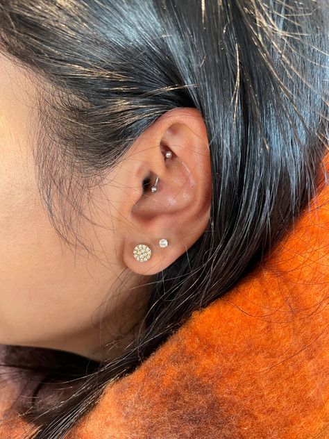 Side profile of a pierced ear with two earlobe piercings and a daith piercing. Woman has long black hair tucked behind her ear.  Woman is wearing an orange scarf. Earlobe Piercings, Double Ear Piercings, Daith Jewelry, Diy Easter Gifts, Pierced Ear, Ear Party, Jewelry Aesthetic, Side Profile, Ear Piercing