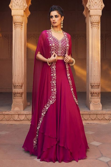 Buy #raspberry #lehenga with asymmetrical hemline. Comes with #embellished #cape and #blouse by #CharuandVasundhara at #Aza #Fashions Shop online now at #Azafashions.com Call +91 99870 70743 or email contactus@azafashions.com for enquiries. #wedding #festive #ethnic #tradional #shopping #shoponline #party #reception #bride Cape Lehenga, Bridal Lehenga Designs, Lehenga Designs Simple, Indo Western Dress, Choli Designs, Designer Dresses Casual, Party Wear Indian Dresses, Lehenga Designs, Indian Fashion Dresses