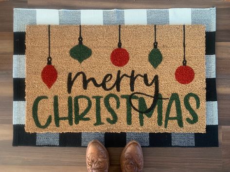 "Welcome your holiday guests with this festive \"Merry Christmas\" outdoor doormat.  Doormats are hand painted with outdoor-rated paint. These coir doormats measure approximately 18\"x30\" in size and have non-slip backing. This mat is suitable for outdoor use but keeping it out of rain and direct sunlight will prolong the life of the design. Listing includes one coir doormat only. Listing photos include display options for your front entry using this doormat." Door Mat Ideas Christmas, Christmas Outdoor Mats, Christmas Painted Doormat, Christmas Rug Painting Ideas, Christmas Rugs Outdoor Diy, Christmas Doormat Ideas Diy, Christmas Door Mat Ideas Diy, Diy Painted Doormat Christmas, Holiday Door Mat