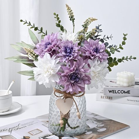 PRICES MAY VARY. FULL OF CLEAN & CLASSIC ACCENT-3 white dahlia and 4 purple dahlia bring out the best in each other, making the whole artificial flowers in vase full of clean vibe. The translucent thick vase has a nice texture on the glass, and the little wooden heart tag also adds a delicate finishing touch. JUST THE RIGHT SIZE-Each bunch of flowers is 16” in length and each thick vase is 6” in height, tall enough that grab your attention when you see them but not too big that they take up a lo Purple Flower Centerpieces, Purple Table Settings, Dahlias Flower, Dahlia Flower Arrangements, Fabric Daisy, Purple Wedding Centerpieces, Home Flower Arrangements, Flower Table Decorations, Purple Centerpieces