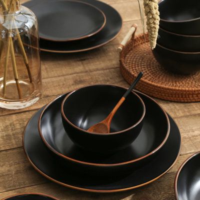 Make a statement with your casual dining ware with the Stone + Lain Brasa dinnerware set. Made in Stoneware and available in several colors–all with brown-edged borders–this rustic-chic combination perfectly accentuates a modern farmhouse style. With service for four, this 32-piece set includes eight 7.76-inch salad plates, eight 10.75-inch dinner plates, eight 33.8fl. oz. pasta plates, and eight 25 fl. oz. round bowls. Stone Lain Color: Black | Stone Lain Brasa 32-Piece Dinnerware Set Stoneware Dishes Sets Modern, Stone Plates, Stone Dishes, Black Dishes Table Setting, Black Dinner Plates, Black Stoneware Dinnerware, Coffee Set Design, Green Dinnerware Set, Black Dinnerware Set