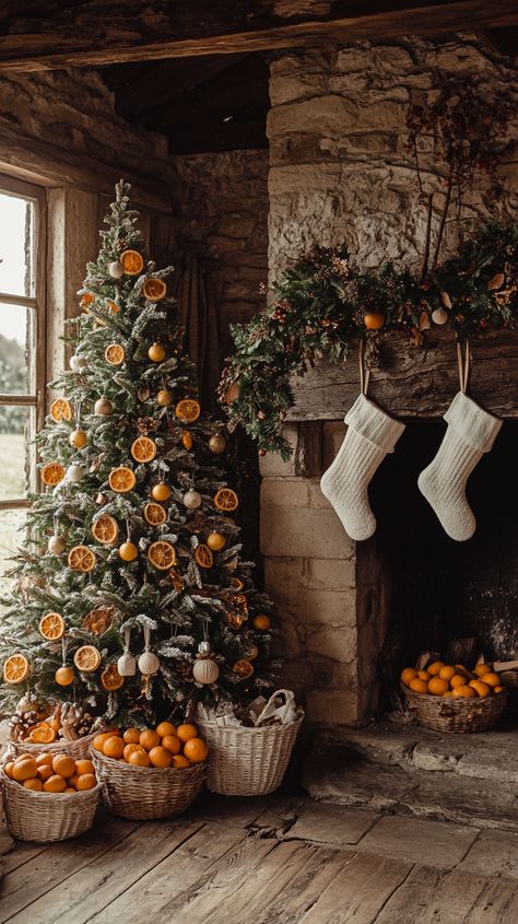 Christmas tree adorned with dried orange slices and wooden ornaments, beside a fireplace with white stockings and orange Leftover Tree Trimming Ideas, Christmas Tree With Natural Ornaments, Orange Slice Garland Christmas Tree, Dried Orange Slices Christmas Tree, Christmas Tree Dried Oranges, Christmas Decor Ideas Orange, Dried Orange Christmas Decor, Dried Orange Garland Diy, Christmas Tree With Dried Oranges