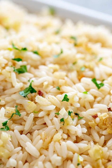 For a super simple and delicious side dish, make this easy Garlic Rice. It is full of flavor and is so simple to make. Tender, fluffy rice, cooked with garlic butter to give you a rice side that is so packed with flavor and goes with anything! Serve this with chicken, meat, fish or veggies! Best Rice With Fish, Rice Pilaf For Fish, Fish Over Rice, Rice Recipes For Salmon, Rice Dish With Fish, Rice Recipes With Fish, Rice Recipes For Fish, Rice Recipe For Fish, Rice That Goes With Fish