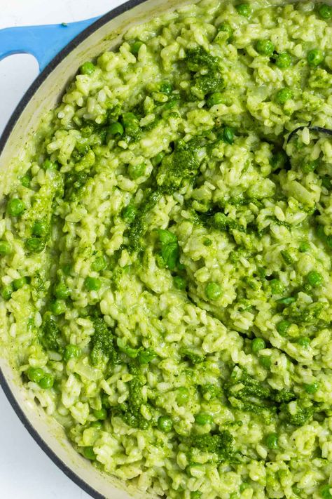 This vibrant pesto risotto pairs bright and herby pesto sauce with creamy risotto, fresh basil, Parmesan cheese, and green peas. It's the perfect springtime dinner for the family, for entertaining guests, or just for a low-fuss weeknight meal. #risotto #pestorisotto #risottorecipe #weeknightdinner #easydinner #familydinner #dinnerrecipe Pesto Risotto Recipes, Pesto Chicken Risotto, Green Pea Risotto, Risotto Recipes Peas, Creamy Risotto Recipes Parmesan, Spring Pea Risotto, Pesto Risotto, Avocado Pesto Pasta, Creamy Risotto