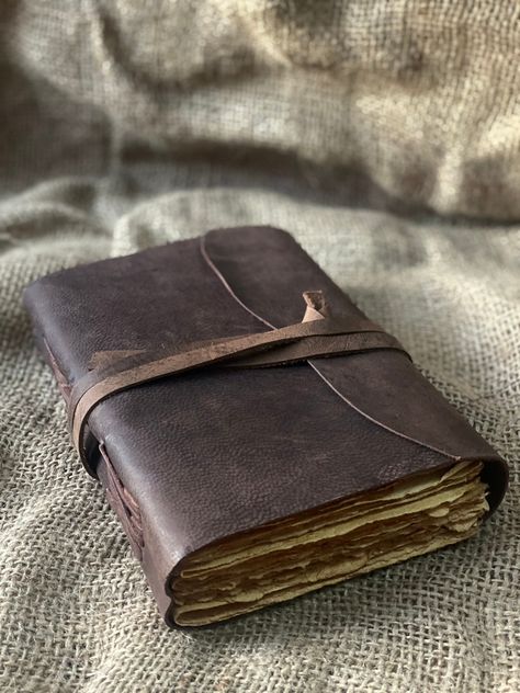 "Beautiful Cow Hide Leather Journals Soft and Durable Dark Brown Genuine Leather, - No glue used. - Hand Stitched. - Binding diary (paper is not refillable). - Real Leather scent. - Deckle Edge paper - each journal is very special Size - (length) 7\" x (Hight) 5\" x (width) 2\" inch. A perfect combination of luxurious leather cover and perfect quality paper. OUR DARK BROWN LEATHERBOUND NOTEBOOKS MAKE HEARTWARMING BIRTHDAY, ANNIVERSARY, VALENTINE'S, GRADUATIONS, ENGAGEMENT, WEDDING GIFTS, CHRISTM Leather Sketchbook Aesthetic, Leather Book Aesthetic, Old Leather Journal, Leatherbound Journals, Cool Journal Covers, Leather Journal Aesthetic, Diy Leather Journal, Old Leather Book, Vintage Diaries