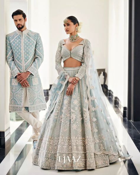 Bride Story on Instagram: “The dreamy icy blue lehenga and sherwani is the ideal assortment of modern elegance and a timeless tale for summertime soirée. All the…” Bride And Groom Indian Wedding Outfit Pastel, Indian Bride Wedding Dress, Day Wedding Outfit Indian, Engagement Lehengas For Bride, Interracial Indian Wedding, Bridal Reception Dress Indian, Indian Wedding Couple Outfits, Bride And Groom Indian Wedding Outfit, Engagement Dress For Groom