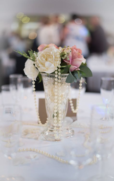 Beautiful table decoration at a wedding at The Arlington. Pearls Wedding Decorations, Pink And Pearl Centerpieces, Pearl And Flower Centerpieces, Wedding Centerpieces Pearls, Pearls Table Decor, Pearl Table Decorations Wedding, Pearls And Prosecco Dessert Table, Pearl Themed Wedding Backdrop, Pearl Vase