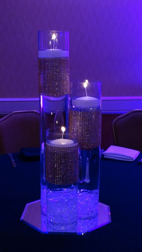 Candle Centerpieces are an elegant and timeless decor option. Purple Sweet 16 Centerpieces, Euphoria Themed Centerpieces, Euphoria Table Decor, Euphoria Prom Theme Decor, Euphoria Table Centerpiece, Bratz Centerpieces, Euphoria Party Table Decor, Euphoria Centerpiece Ideas, Euphoria Prom