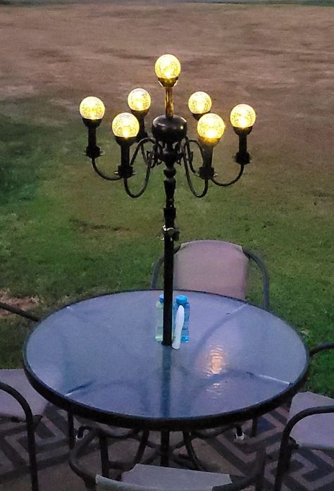 Recycle, Reuse and Repurpose! | The wind took out my patio umbrella, so I found a $5 thrift store chandelier, black spray paint, and a couple of solar lights, I then did a little cre... | Facebook Creeping Thyme, Fancy Table, Chandelier Black, Black Spray Paint, Outside Patio, Backyard Projects, Repurposed Furniture, Solar Lights, Repurpose