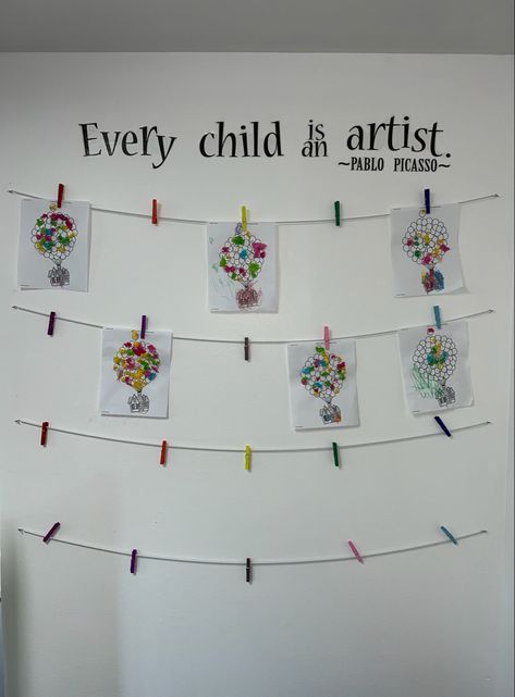 Display Kids Artwork In Classroom, Daycare Wall Art Ideas, Student Art Wall Classroom, Artwork Display Classroom, Wall Of Kids Artwork, Art Wall Quotes Preschool, Nursery Art Area Ideas, School Work Display At Home, School Art Wall Display