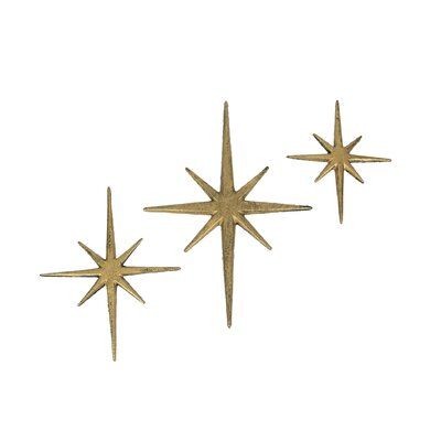 This trio of 8 pointed compass stars adds a wonderful Mid-Century modern touch to your indoor or outdoor decor. Crafted of cast iron, the stars feature an antiqued metallic gold enamel finish to give them a great aged look. The large star measures 8.75 inch long, 0.25 inch wide, 12 inch high; the medium star measures 7 inch long, 0.25 inch wide, 8.75 inch high; and the small star measures 5.75 inch long, 0.25 inch wide, 6.75 inch high. Hang them together or separately for a perfect accent to vin De Stijl, Stars Wall Decor, Atomic Starburst, 3d Wall Decor, Big House, Metal Stars, Mid Century Modern Decor, Star Wall, Mid Century Modern Art