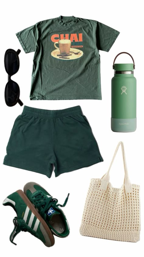 Dark green shirt with a photo of a mug and the words chai in orange, dark green shorts, dark green adidas, round black sunglasses, white crochet tote bag, green hydro flask. Camp Inspired Outfits, Comfy Granola Outfits Summer, Camp Clothes Aesthetic, Green Girl Outfit, Camp Outfits Aesthetic, Comfy Summer Outfits Aesthetic, Summer Camp Fits, Green Outfit Summer, Camping Outfit Ideas