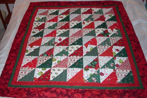 Beautiful, festive, Christmas quilt made of all cotton fabrics with a non allergenic batting. Good to snuggle up in during the holidays with your hot cocoa. Pattern is alternating triangles in traditional Christmas greens and reds.  The backing fabric is a green, red and gold plaid.. This quilt will give you many years of happy use!  Measurements are 50 in x 43 in.  Machine wash cold, delicate cycle, dry low/gentle cycle. Thank you for visiting my shop! Christmas Lap Quilt, Animal Baby Quilt, Half Square Triangle Quilts Pattern, Christmas Greens, Patchwork Quilting Designs, Christmas Quilt Blocks, Traditional Quilt Patterns, Lap Quilt Patterns, Charm Pack Quilts