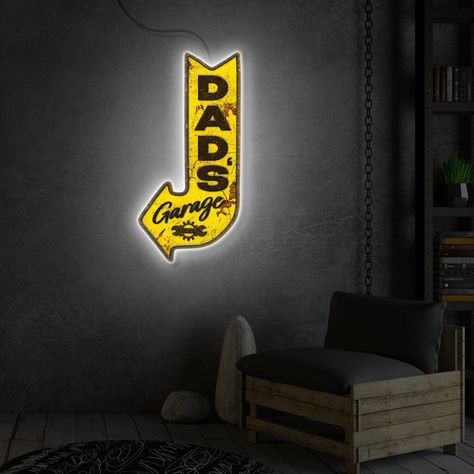 🔧 Transform your dad's haven into a personalized retreat with our "Dad's Garage" Neon Light Sign - a dynamic fusion of nostalgia and modern flair that adds a touch of character to his cherished space! 🌟 Featuring the unmistakable glow of "Dad's Garage" LED Sign, this customized masterpiece is more than just a sign; it's a tribute to the cherished memories and countless hours spent tinkering in the workshop. ✨ Key Features: - Customized Elegance: Our Garage LED Sign allows you to create a perso Custom Garage Signs, Art Garage, Garage Wall Decor, Led Art, Arrow Art, Custom Garages, Dads Favorite, Vintage Aesthetics, Garage Lighting