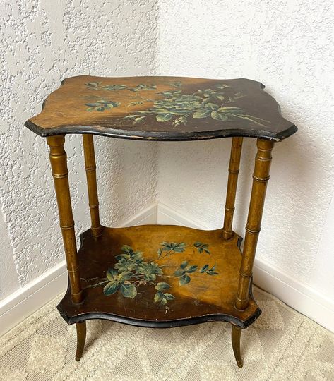 ART NOUVEAU 2 tier table with painted tops, Emile Gallé style table, French side table   Charming table in solid wood ART NOUVEAU of Emile Gallé style with 2 tops supported by feet in the shape of bamboo stems which remind of traditional Japanese furniture. On the upper tray a complex painting represents flowering branches with a butterfly in green tones on a background of 2 shades of brown. The same pattern is repeated on the lower shelf. The legs are gold colored. The table shows some wear of Art Nouveau Table, French Side Table, Flowering Branches, Painted Coffee Tables, Antique Side Table, Japanese Furniture, Table Art, Dream Room Inspiration, Style Table