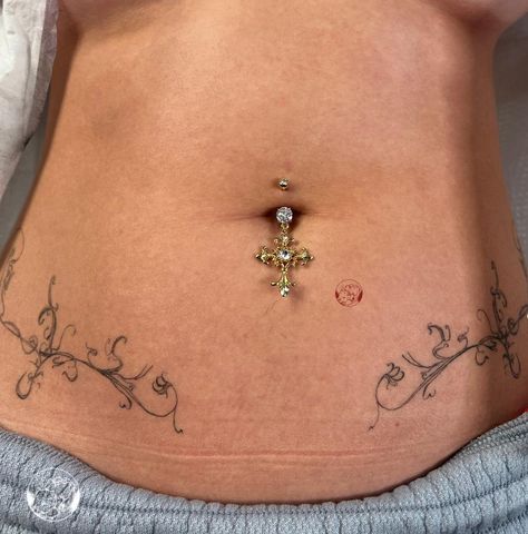 Flattering Stomach Tattoo, Lower Pelvis Tattoo Women, Spine Bone Tattoos For Women, Knee Border Tattoo, Skeleton Tramp Stamp, Unique Lower Back Tattoos, Hole Band Tattoo, Hole Tattoo Band, Symetric Tattoo Stomach