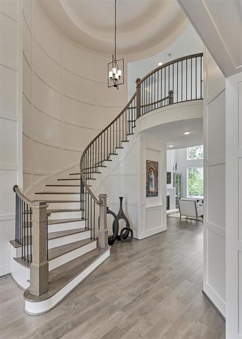 Light flows through entire foyer Interior Stairs Ideas Staircases, Curved Staircase Lighting, Second Story Hallway Ideas, Large Open Staircase, Grand Foyer Staircase, Big Staircase Grand Entrance, Curved Stair Railing Ideas, Round Staircase Railing Design, Unique Staircase Railing