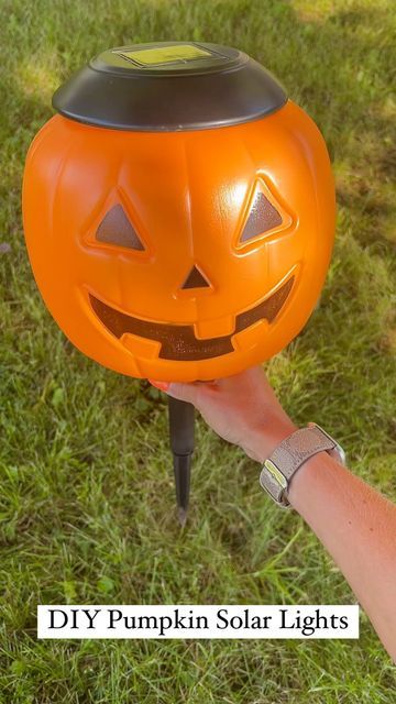 Pumpkins On Fence Posts, Plastic Pumpkin Over Solar Lights, Lighted Pumpkins On Porch, Pumpkins With Lights, Pumpkin Lights Outside, Pumpkin Bucket Solar Lights, Diy Pumpkin Bucket Decor, Halloween Pumpkin Bucket Ideas, Plastic Pumkin Decoration Ideas Easy