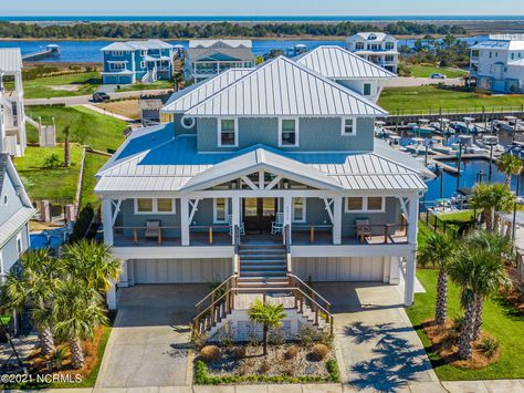 Twenty-five feet above sea level in the gated community of Helms Port sits a coastal home with panoramic triple views of the marina, the intracoastal waterway and the Atlantic Ocean. Engineered and constructed with FORTIFIED Gold(tm) standards, high im... Beach Cottage Exterior, Kure Beach, Intracoastal Waterway, Cottage Exterior, Wrightsville Beach, Coastal Home, Wilmington Nc, House Built, Sea Level