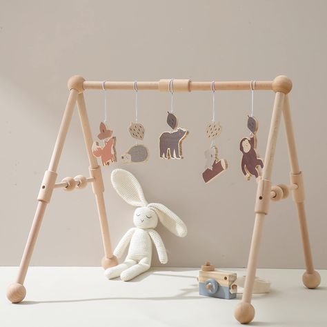 PRICES MAY VARY. 🦓【Excellent Design】: The wooden gym frame is made of unfinished beech, sanded to be smooth. Free of any chemicals. wooden baby gym comes with 5 wooden toys, including Bear, hedgehog, koala, fox, orangutan,5 Cute pendant + 1* Natural Wooden Baby Play Gym.It's child safe and saliva resistant! It’s great for teaching your baby to grab, crawl, sit up, stand up and go for the first steps. 🦁【Natural and Healthy】The baby gym retains the natural color of the wood, and the toys has a m Baby Jungle Gym, Wooden Play Gym, Wooden Baby Gym, Baby Play Gym, Activity Gym, Jungle Gym, Play Gym, Baby Growth, Hanging Bar