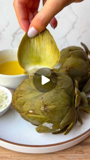 Alexa Santos on Instagram: "It blows my mind so many people have never tried these! 😳 artichokes dipped in butter/cheese have always been one of my family’s favorite treats… it’s so simple yet so wonderful 🥹 get the recipe below‼️

Ingredients:
-kosher salt
-2 raw artichokes 
-4 tablespoons salted butter 
-2 cloves garlic, minced
-juice from 1 lemon
-Parmesan cheese, freshly grated

Directions:
-Bring a large pot of water to boil and add in a generous amount of salt. Place in the 2 artichokes to cook, making sure they’re covered by water (or at least mostly covered). Cover the pot and boil the artichokes for 45 minutes-1 hour. You can tell they’re done when you can easily stick a butter knife stuck into the stem area (it should be quite tender). Remove from the water and set aside.
-Plac Boiled Artichoke Recipes, Fresh Artichoke Recipes, Boiled Artichoke, Boiling Artichokes, Artichoke Recipes, Butter Cheese, Artichoke Dip, Butter Knife, Butter Recipe