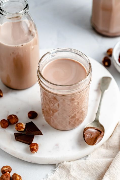 This homemade hazelnut milk recipe has a boost of chocolate flavor that makes it taste just like Nutella! Skip the expensive, store-bought kind and make this chocolate hazelnut milk right at home. Enjoy it on its own, in coffee, desserts and more! #hazelnuts #hazelnutmilk #dairyfree #vegan #nutmilk Hazelnut Milk Recipes, Dairy Free Nutella, Nutella Milk, Nut Milk Recipe, Homemade Nut Milk, Coffee Desserts, Hazelnut Milk, Ambitious Kitchen, Homemade Crackers