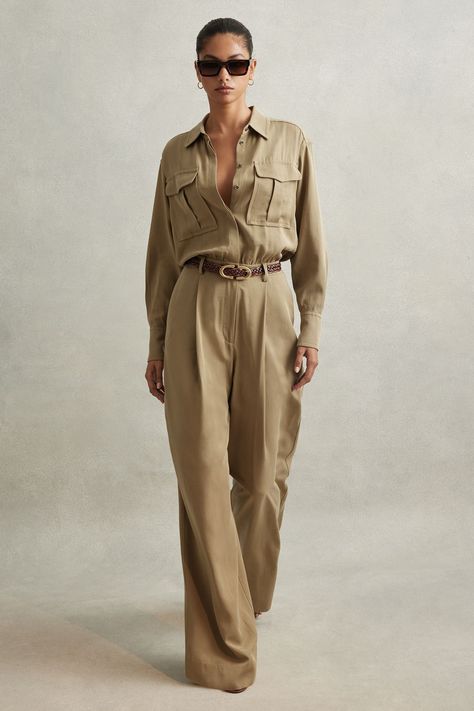 Find REISS Liliana Lyocell Wide Leg Jumpsuit on Editorialist. Made from a smooth lyocell fabric, the Liliana jumpsuit drapes down the body with a wide-leg finish. It has a relaxed, shirt-style top which blousons slightly at the belted waist. 100% lyocell. Button-front closure. Chest pockets. Front pleats. Waist belt. Side pockets. Wide leg. The model is wearing a size 8. Measurements of model: Height 5 10 / 177.8cm Chic Jumpsuit Outfit, Shirt Style Tops, Lyocell Fabric, Jumpsuit Outfits, Jumpsuit Chic, Jumpsuit Outfit, Green Jumpsuit, Jumpsuit Online, Of Model