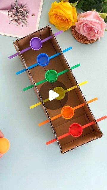 paper crafts creator on Instagram: "kindergarten crafts: don’t throw away used cartons and bottle caps. i’ll teach you how to make a fun ball passing toy in a few simple steps.

#parentchildhandicraft #homemadetoys #upcyclecraft #handmadediy #childhandicraft #creativecrafts #diyprojects #recycledcrafts #kidscrafts #funprojects" Kindergarten Toys Ideas, Bottle Tops Crafts, Art Activities With Recycled Materials, Recycled Activities For Preschoolers, Paper Ball Craft, Simple Games For Kids, Simple Art And Craft For Kindergarten, Games With Recycled Materials, Toy Out Of Recycled Material