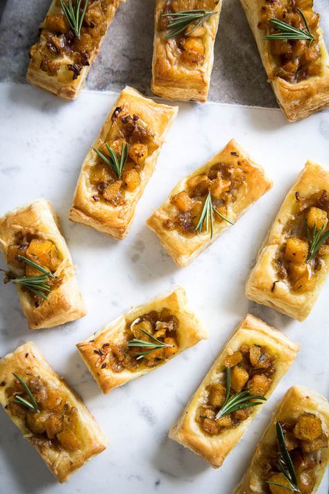 These Pumpkin & Rosemary Puff Pastry Bites are incredibly easy to pull together and make for the perfect bite-sized fall appetizer. Savory Fall Pastries, Pumpkin Appetizers Savory, Fall Amuse Bouche, Fall Small Bites, Fall Party Hourderves, Thanksgiving Appetizers Puff Pastry, Fall Appetizers For A Crowd, Savory Pumpkin Appetizers, Bite Size Thanksgiving Appetizers