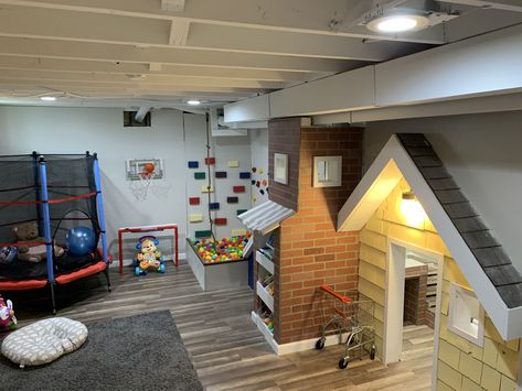 We got a ball pit, rock climbing wall, play house with kitchen, art area, books, trampoline, slide and much more Playroom With Trampoline, Trampoline In Playroom, Basement Trampoline, Basement Playhouse With Slide, Indoor Trampoline Playroom, Ball Pit Playroom, Playroom Slide, Basement Play Area, Kids Indoor Play Area