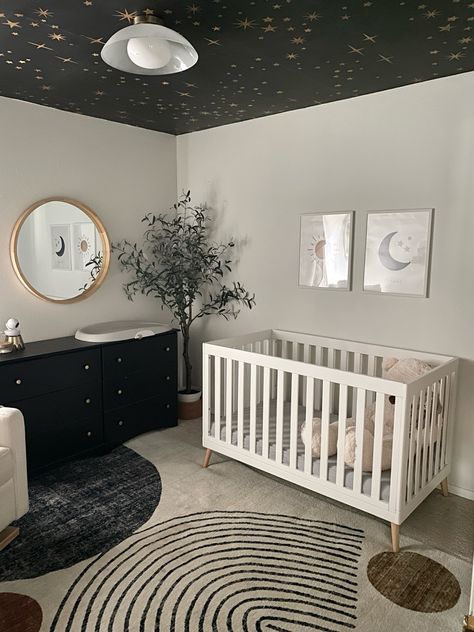 My baby boy’s little dreamer nursery! 💫🌠☁️🌑☀️ moody, modern, sophisticated and playful nursery interior design. Ceiling wallpaper, moon themed light fixture, abstract area rug and more linked on LTK!

Interior Designer: Homes by Simmone I Love You To The Moon And Back Nursery, Nursery Ideas Dark, Black And White Boy Nursery, Moon Themed Bedroom, Moody Baby Nursery, Moon Nursery Theme, Celestial Nursery Theme, Monochromatic Nursery, Contemporary Baby Nursery