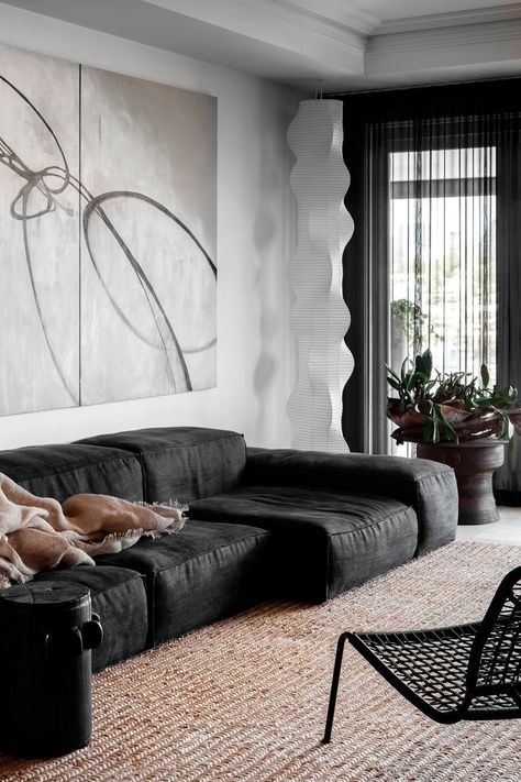 monochrome living room with slouchy black couch and jute rug. a sculptural paper lamp hangs in the corner while a timber drum is filled with indoor plants Monochrome Apartment, Sydney Apartment, International Interior Design, West Home, Visual Style, Modern Barn House, Interior Design Awards, Beach House Interior, Barn Style House