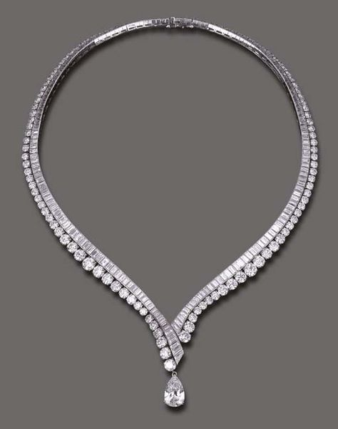 AN ELEGANT DIAMOND NECKLACE, BY VAN CLEEF & ARPELS  The flexible V-shaped baguette-cut diamond line, enhanced by graduated circular-cut diamond trim, the front suspending a detachable pear-shaped diamond, weighing approximately 4.11 carats, mounted in platinum and 18k gold, 16 ins., with French assay marks and maker's mark, in a Van Cleef & Arpels blue suede envelope case Van Cleef Arpels Blue, Elegant Diamond Necklace, Diamond Necklace Simple, Diamond Necklace Designs, Simple Diamonds, Solitaire Pendant Necklace, Diamond Jewelry Necklace, Van Cleef Arpels, Van Cleef