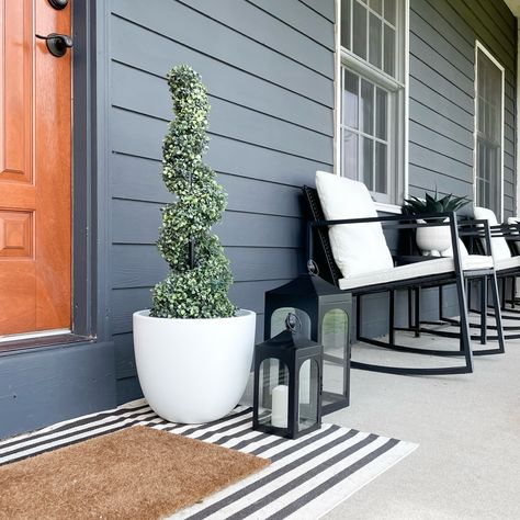 Black house metal rocker front porch cedar door lanterns faux topiary Front Porch Seating Ideas Modern, Small Front Porch Chairs, Modern Front Porch Seating, Small Porch Seating Ideas, Minimal Front Porch, Front Porch Minimalist, Small Front Porch Seating, Aesthetic Front Porch, Outdoor Porch Lighting