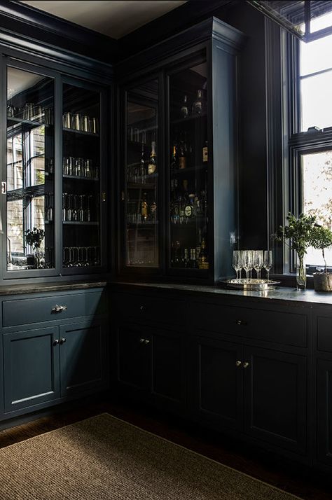 Black marble countertops on a black butler pantry built-in feature glass doors and brass cup pulls. Black Glass Door, Black Marble Countertops, Sage Design, Glass Door Cabinet, Bourbon Room, Whiskey Room, Butler’s Pantry, Transitional Dining Room, Dark Kitchen