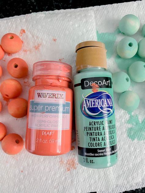 Painted wood bead hack Painted Wood Bead Garland Diy, Easy Way To Paint Wooden Beads, Painting Wooden Beads Diy, Wood Bead Keychains, Painting Beads Wooden, How To Dye Wood Beads, Wooden Bead Crafts Diy, How To Paint Wooden Beads, Painting Wood Beads