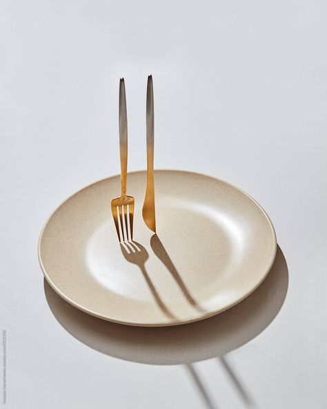 Stainless steel cutlery vertical with empty plate on a light background, copy space. by Yaroslav Danylchenko for Stocksy United Restaurant Cutlery, Empty Plate, Starting A Restaurant, Bistro Food, Eating Utensils, Cafe Bistro, Stainless Steel Cutlery, Light Background, House Interior Decor