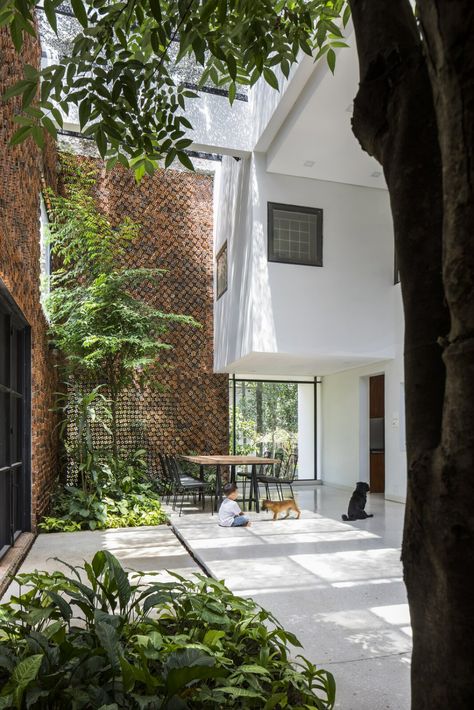 Photo 8 of 23 in A Biophilic Home in Vietnam Impresses With a Hollow-Brick “Breathing Wall” - Dwell Wooden Sliding Doors, Square Windows, Two Storey House, Patio Interior, Small Outdoor Spaces, City House, Indoor Air Quality, Brick Wall, House Front