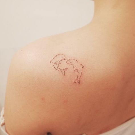 ©wittybutton_tattoos Two Dolphins Tattoo, Fine Line Dolphin Tattoo, Dolphin Tattoo For Women, Dolphin Tattoos, Dolphin Tattoo, Dolphins Tattoo, Beach Tattoo, Pink Dolphin, Disney Tattoo