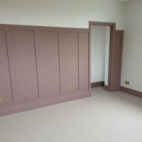 A neutral, textured carpet, paired with panelling and skirting boards painted in a muted, dusky pink tone. The image features traditional style radiators painted in a glossy white shade. Sulking Room Pink Utility, Bedroom Inspirations Feature Wall, 2 Colour Bedroom Wall, Cider Rose Farrow And Ball, Dust Pink Bedroom, Sulkingroompink Farrow And Ball, Dusty Pink Dressing Room, Sulking Room Pink Bedroom Ideas, Dark Pink Panelling