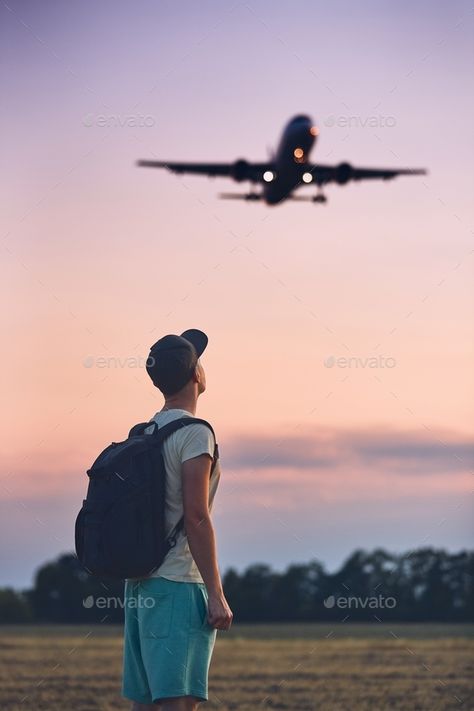 Traveler is looking at the landing airplane by Chalabala. Young man (traveler) against moody sky with landing airplane. Prague, Czech Republic.#Chalabala, #Young, #man, #Traveler Landing Airplane, Athletic Pictures, Man Looking Up, Moody Sky, Travel Cheap, Earth Photos, Bike Pic, Special Images