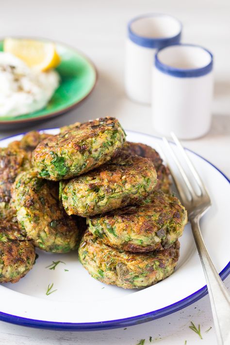 Vegan Greek zucchini fritters are a beautiful mezze dish. Traditionally, they contain eggs and feta, but we've managed to veganise ours to a great effect. Couscous, Greek Zucchini, Courgette Fritter, Zucchini Fritters Recipe, Recipes Greek, Lazy Cat Kitchen, Vegan Greek, Cat Kitchen, Vegan Zucchini