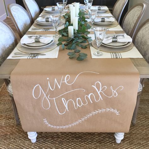 Thanksgiving easy table setting. Kraft paper runner.  Magnolia home placemats. Fresh eucalyptus and candles Low Budget Thanksgiving Table Decor, Butcher Paper Food Display, Thanksgiving Craft Paper Table Runner, Silver Thanksgiving Table Decor, Thanksgiving Set Up For Large Family, Friendsgiving Table Setting Disposable, Diy Friendsgiving Decor, Simple Dinner Party Table Decor, Mexican Thanksgiving Decor