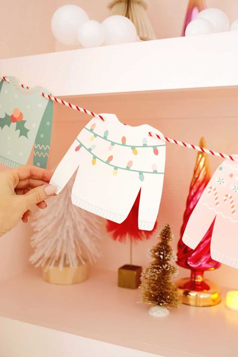 Christmas Sweater Garland DIY (With Free Printable!) - A Beautiful Mess Holiday Banners Ideas, Cricut Christmas Garland Ideas, Christmas Decorating Party Ideas, Holiday Banners Diy, Diy Christmas Banner Ideas, Cricut Crafts Christmas, Christmas Decor Printables Free, Diy Christmas Paper Garland, Christmas Cardstock Crafts