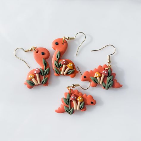 swipe to see all the dinos for this weekend!➡️ dinosaur earrings in 10 designs, dropping this saturday (march 9th) at 1PM pacific ! each of them will be available with both brontosaurus and stegosaurus options🥹🥰 i am SO EXCITED tysm to everyone who suggested i make stegosauruses because they are very adorable i think ??😫😫😫 Polymer Clay Dinosaur Earrings, Polymer Clay Dinosaur, Clay Dinosaur, Mushroom Accessories, Homemade Clay, Clay Pendants, Dinosaur Earrings, Clay Stuff, March 9th