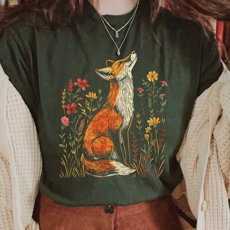 Wildflower Fox Shirt, Cottagecore Shirt, Forestcore T-Shirt, Whimsical Shirt, Vintage Aesthetic. 📣 INFORMATION * All shirts are UNISEX * 100% Airlume combed and ringspun cotton (fiber content may vary for different colors) * Wash and dry normally (on cool for best results) 👕 SIZING * For an oversized fit, select two or three sizes up from your normal size * Model is wearing size L * Sizing runs true to size * Most women find their typical size works best, since they are meant to fit a touch lo Envy Clothing, Cottagecore Clothes, Fox Shirt, Cottagecore Shirt, Embroidered Tshirt, Really Cute Outfits, Vintage Aesthetic, Embroidered Shirt, Outfits Aesthetic