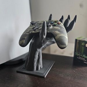 Materials: PLA, Plastic, Biodegradable Plastic  Printed In Black Demon Hand Controller Stand Holder Gaming 3D Printed Fantasy Holder Gaming Accessories Twitch Streaming Office Decor Playstation Xbox Controller Stand 3d Print, Streaming Office, 3d Printing Ideas Creative, Black Demon, Controller Holder, Controller Stand, Twitch Streaming, 3d Ideas, Demon Souls