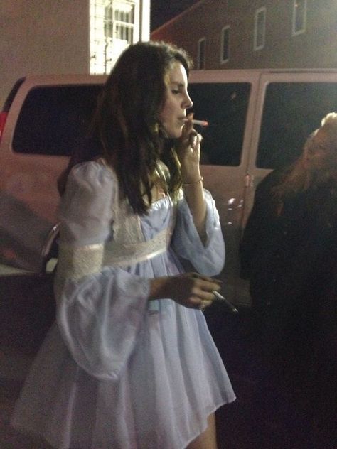 Lana Del Rey wearing a blue and white lace babydoll dress outside after a concert signing autographs dark brown natural beach waves hair Ultraviolence era smoking a cigarette Lana Del Rey, A Man, A Woman, Hair, White