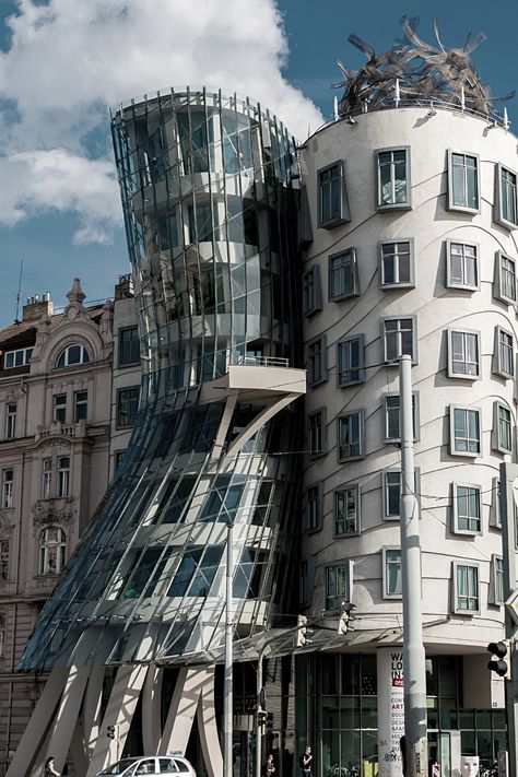 Dancing House, located in Prague, Czech Republic, is undoubtedly one of the worldâs most famous deconstructivist buildings. The structure, named after the famous dance duo Fred Astaire and Ginger Rogers, is a deep philosophical tradition that criticizes western rationalism. In other words, the name Dancing House is just an inadequate mention of looks. However, the building is one of Pragueâs icons today, and it is hard to say that it does not resemble the silhouette of two dancing people. Frank Gehry Dancing House, Two Dancing People, Deconstructivist Architecture, Fred Astaire And Ginger Rogers, Dance Duo, Dancing People, Dancing House, Deconstructivism, Fred And Ginger