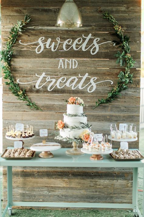 Wedding reception cake table sweets and treats wood backdrop His And Her Dessert Table, Desert Table Ideas Simple, Backdrop Behind Cake Table, Sweet Table Wedding Rustic, Wedding Reception Treats, Wedding Table Dessert, Outdoor Wedding Dessert Table, Cake Table Display Ideas, Cake And Dessert Table Wedding